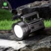 LED search light 7045 with black housing and integrated handle placed on outdoor rocks.