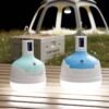 LED camping lantern 7860 and 7861 placed on a wooden table providing outdoor illumination.